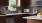 a kitchen with a white countertop and wood floors
