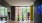 a gym with treadmills and wood floors with a large mirror