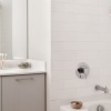 a white bathroom with a large mirror