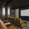 a movie theater with seats and a large screen