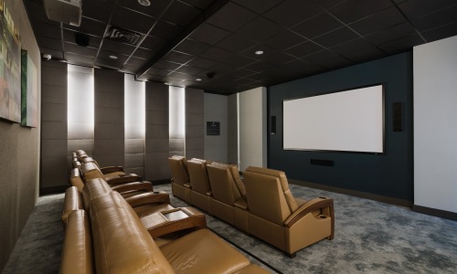 a movie theater with seats and a large screen