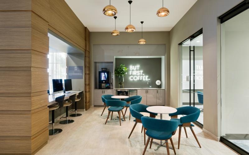 a room with a table chairs and a tv