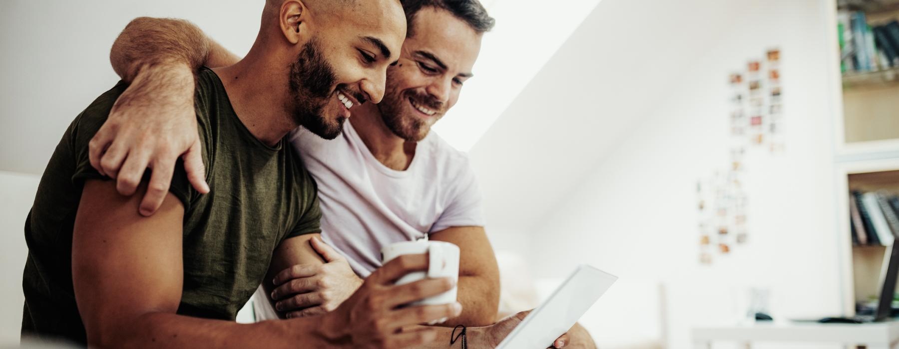 two men holding a computer